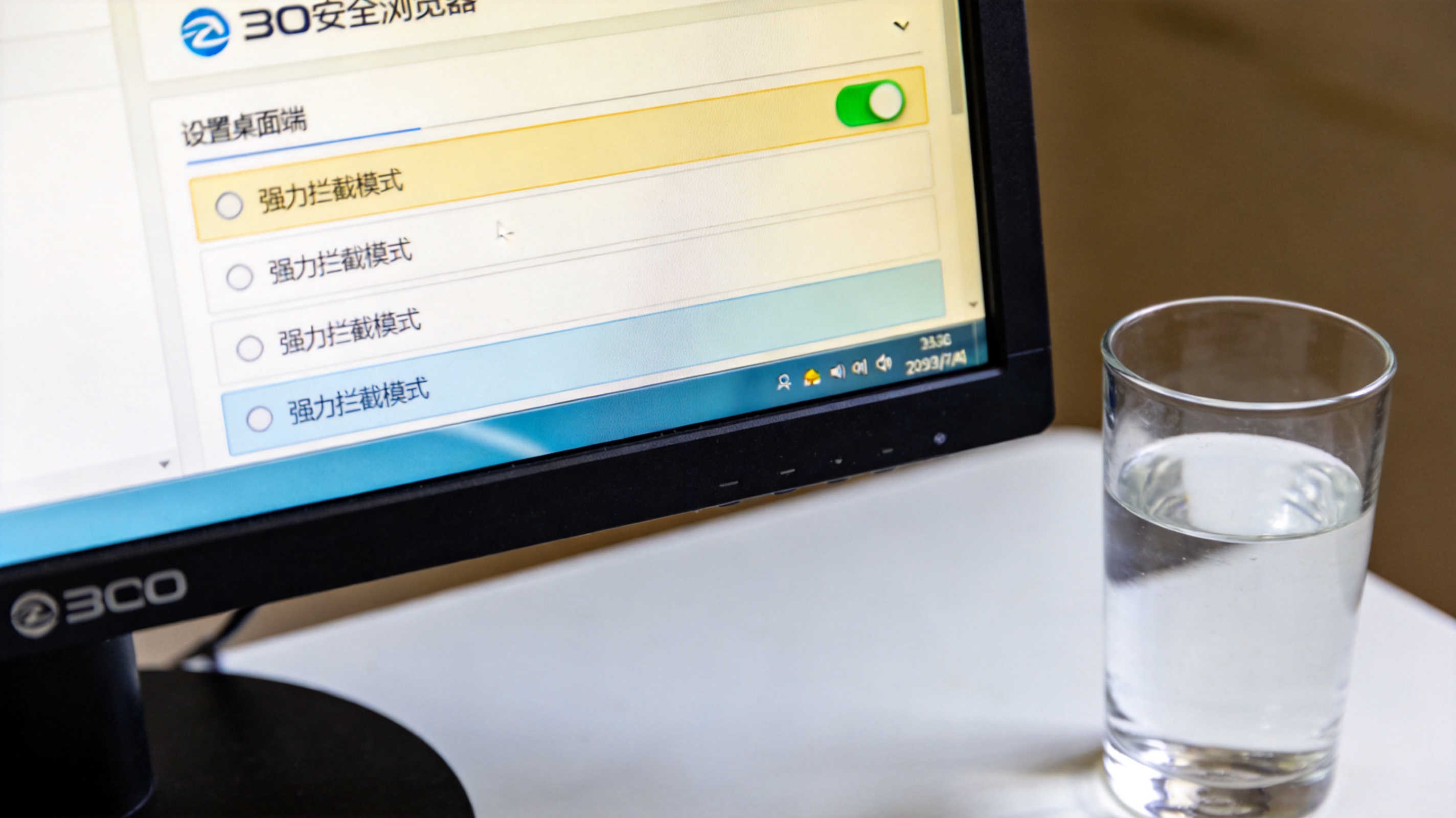 电脑桌面，屏幕显示桌面端360安全浏览器的设置页面，广告拦截选项下的强力拦截模式处于开启状态，桌面角落放着半杯温水，室内自然光