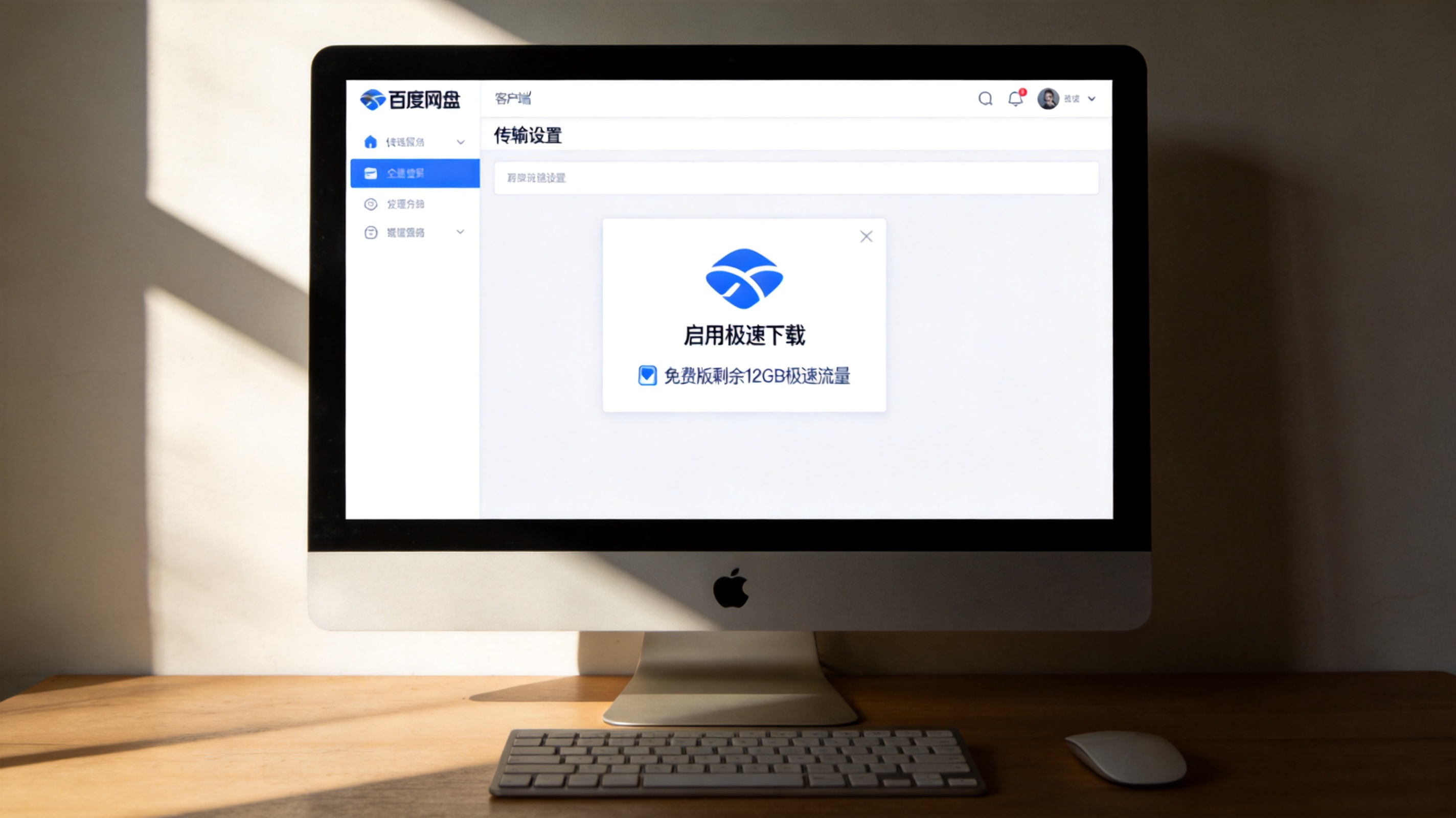 电脑桌面，屏幕显示百度网盘客户端的传输设置界面，“启用极速下载”选项已勾选，旁边显示免费版剩余12GB极速流量，室内自然光